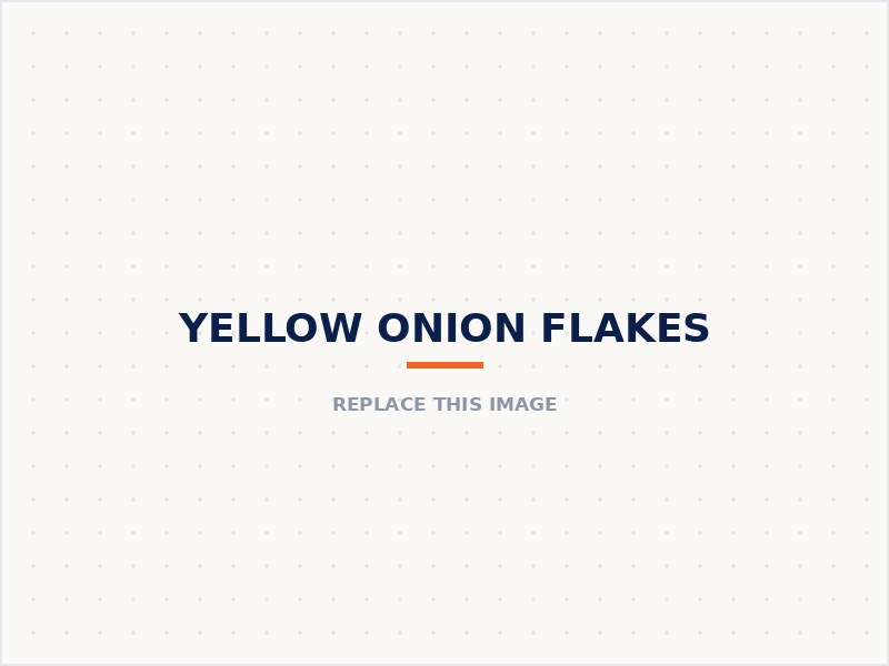 Yellow onion flakes in a wooden bowl beside whole yellow onions
