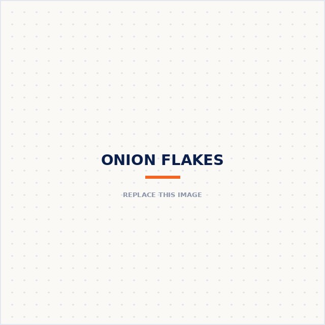 Wooden bowl of white onion flakes next to a whole onion