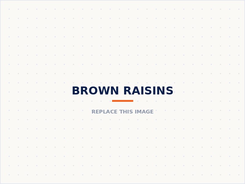 Brown raisins in a wooden bowl with fresh grapes